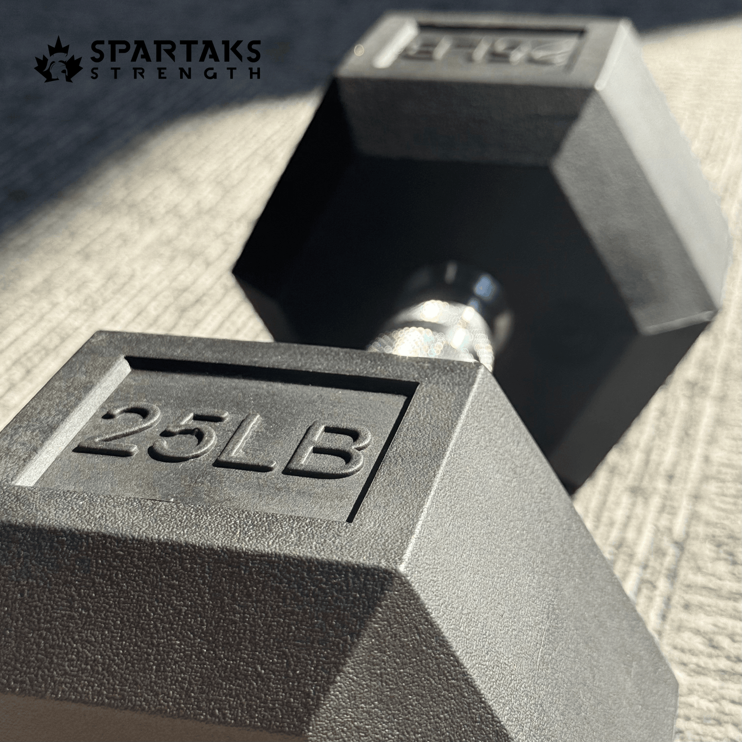Spartaks Strength 5–80LB Hex Dumbbells showing a 25LB dumbbell from a close-up angle.