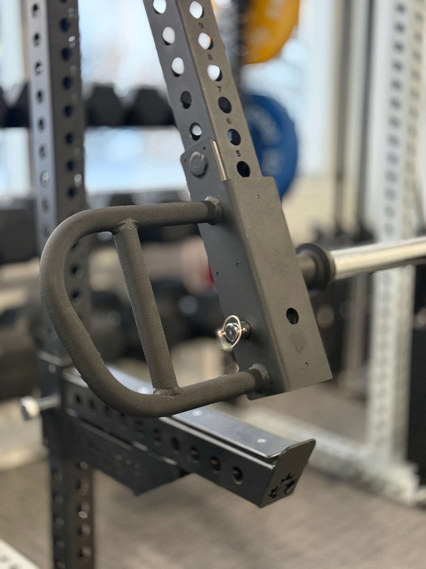 Spartaks Strength 3"X3" Jammer Arms attached to a power rack in a gym.