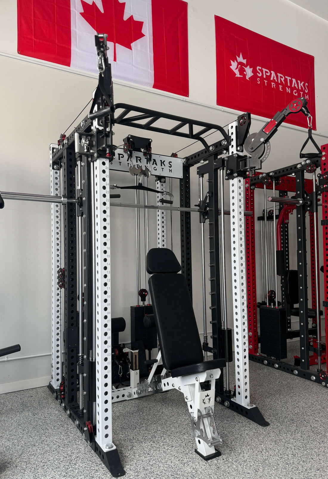 Image of a Spartaks Strength functional trainer showcasing its cable system and adjustable seat for effective workouts.