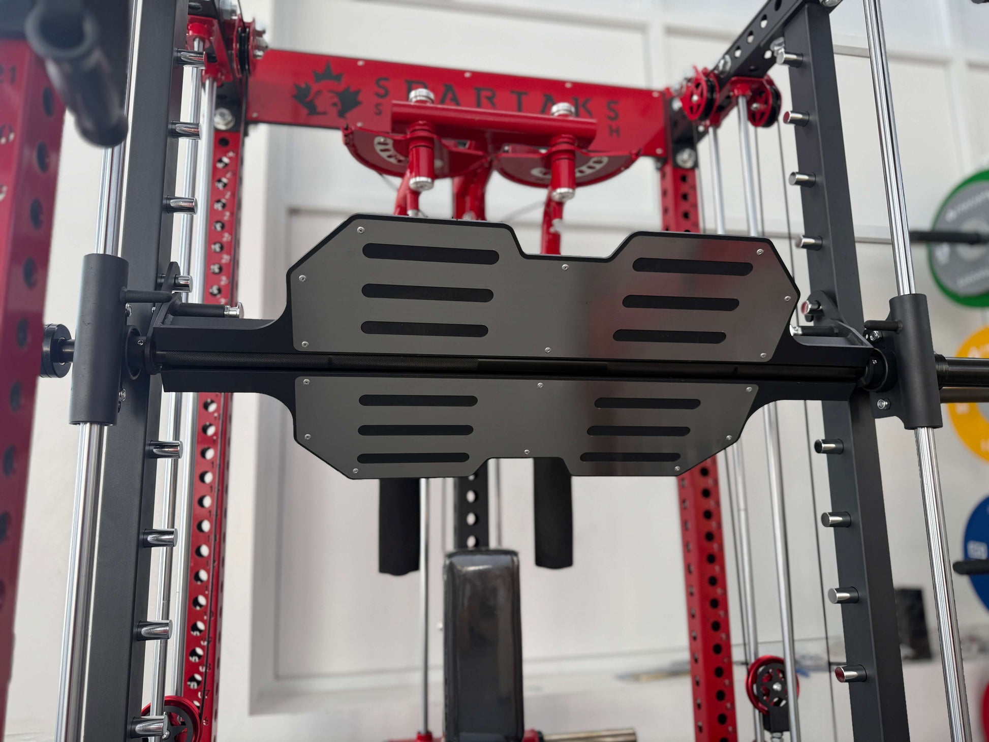 Spartaks Strength Leg Press Pedal Attachment for Smith Machine, showcasing versatility in gym equipment.