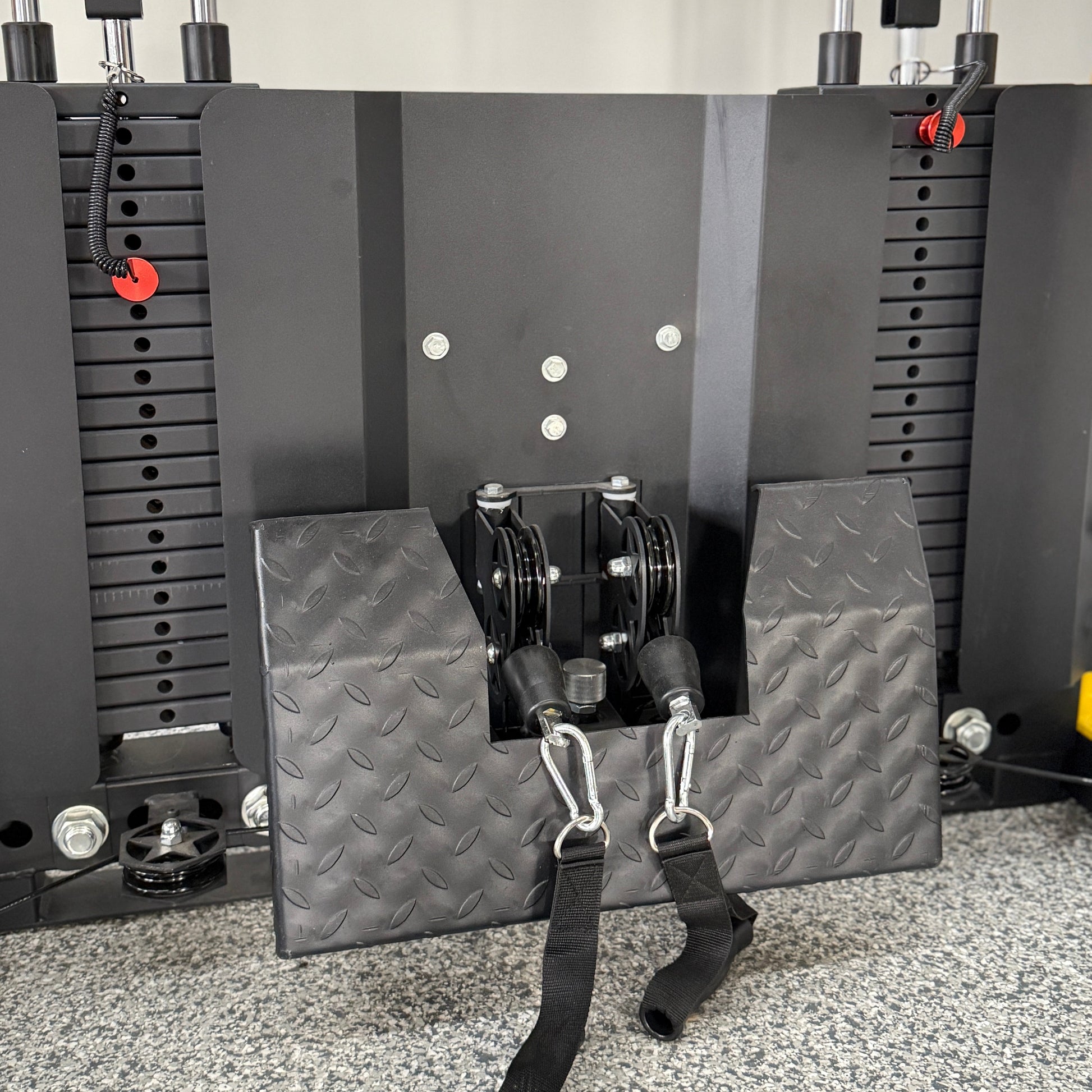 Textured metal footplate for functional trainer attached to a double weight stack and dual pulleys