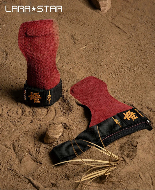 Lara Star Cowhide Palm Guards displayed on sandy surface, ideal for strength training and grip support.