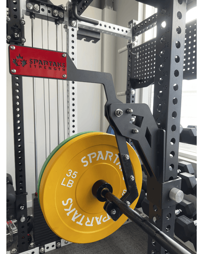 Spartaks Strength Adjustable Monolift Rack Attachment with 35 LB weight plate on power rack in home gym.