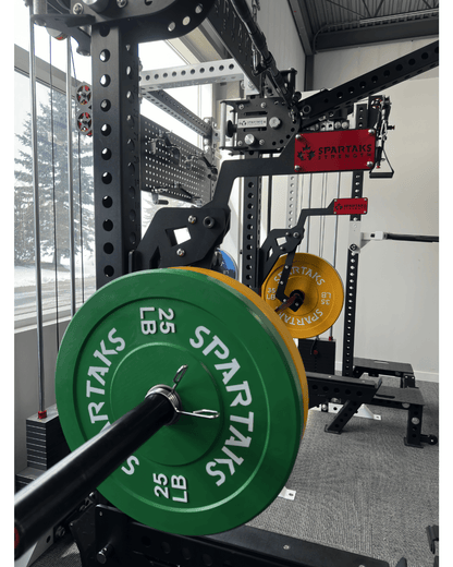 Spartaks Strength Adjustable Monolift Rack Attachment with weights in a home gym setting.